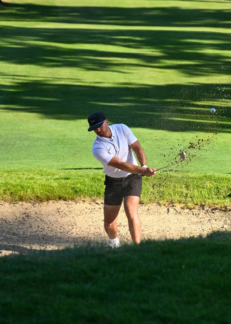 Micah Houston hitting a bunker shot